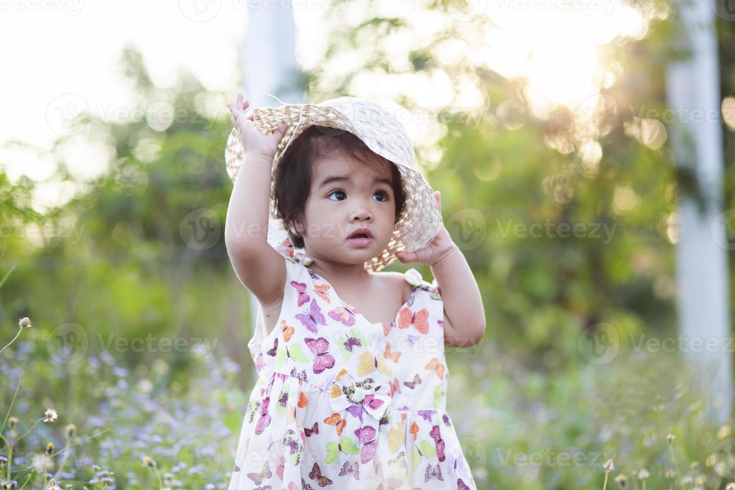 Cute girl smiling brightly in the setting sun photo