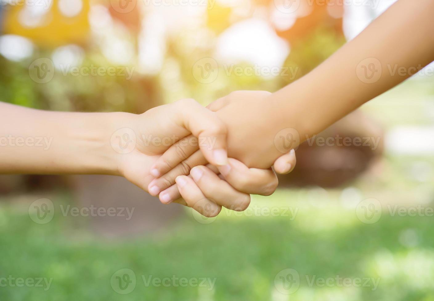 Happy couple holding hands in the sunset photo