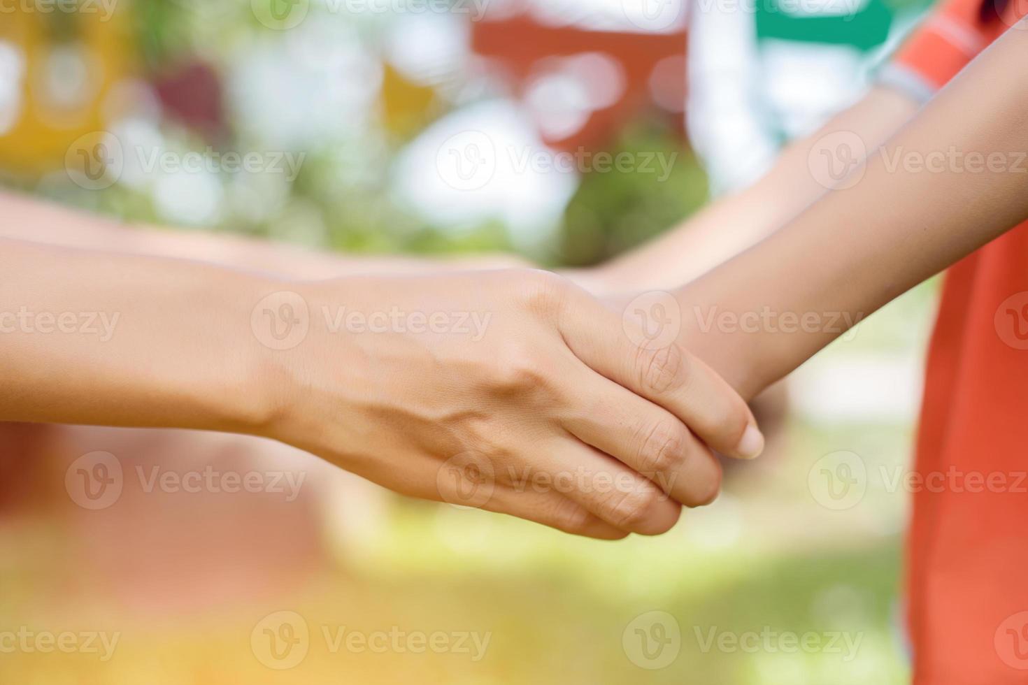 Happy couple holding hands in the sunset photo