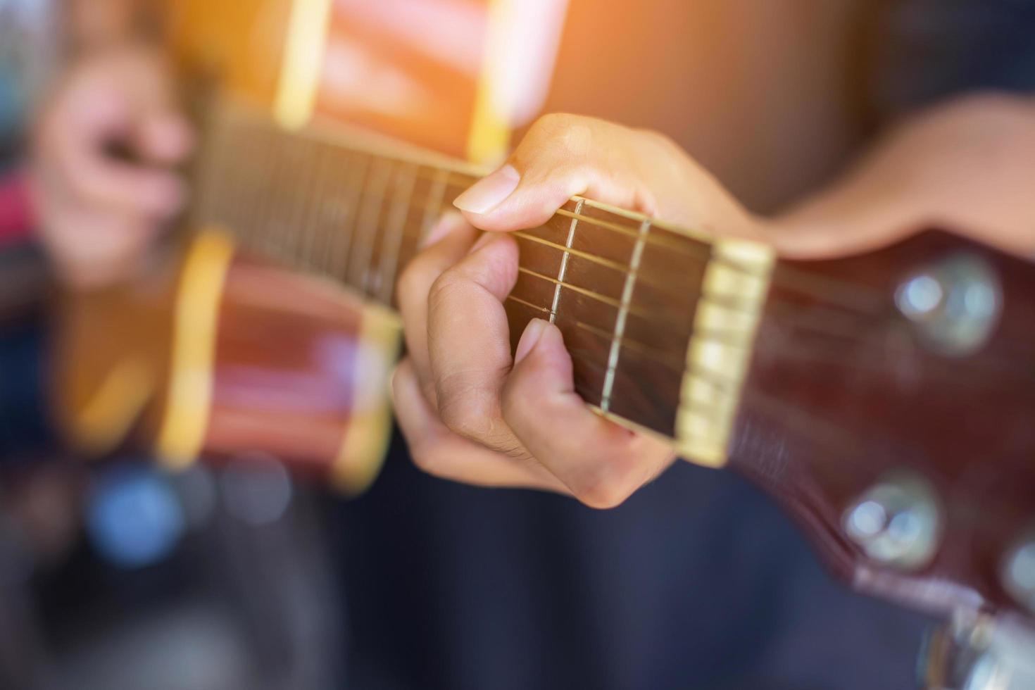 Close up man's hand playing the guitar. photo