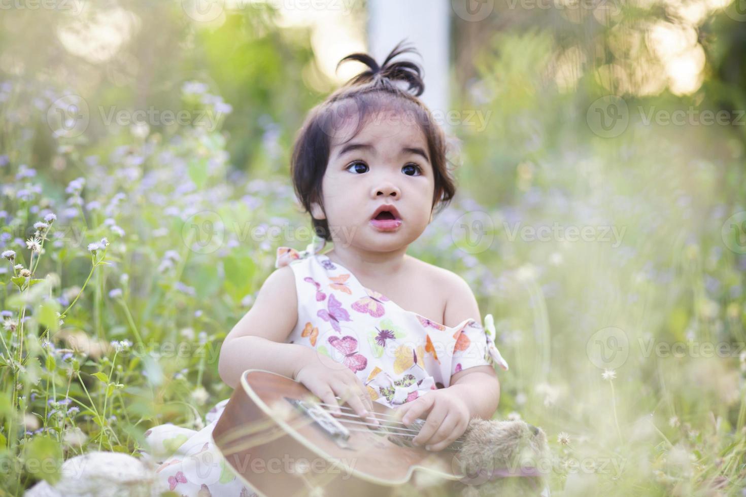 Cute girl smiling brightly in the setting sun photo
