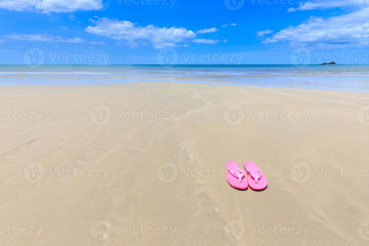 Pink sandals on the beautiful beach photo