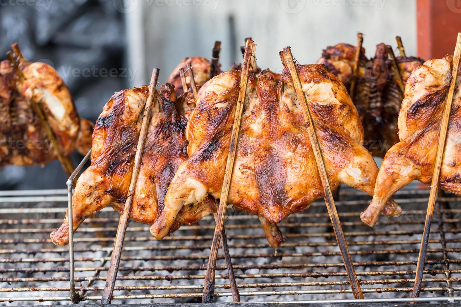 Hot roasting chicken on grill barbecue photo