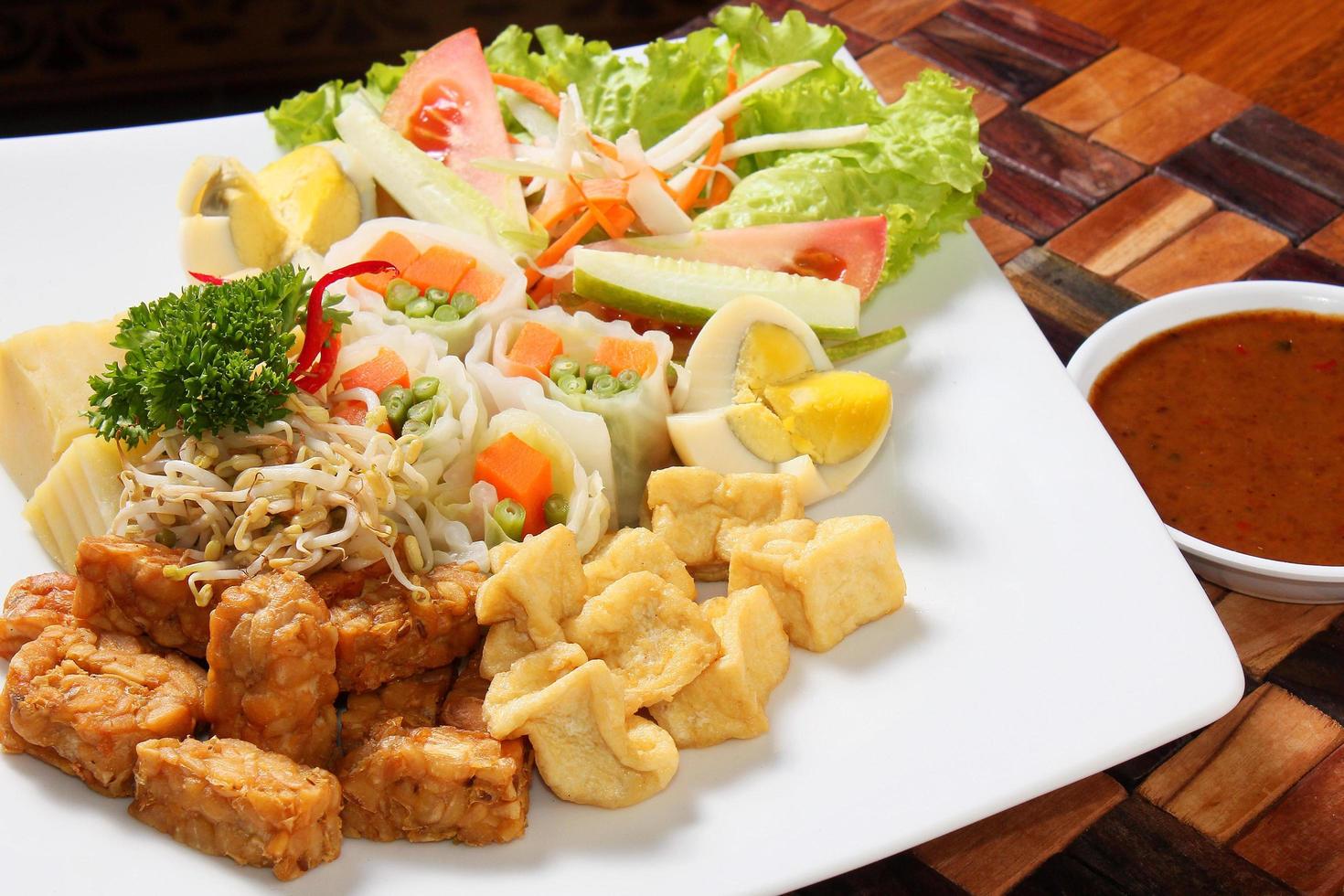 Gado-gado, is a traditional Indonesian dish. Consists of a mixture of pieces of bean sprouts, carrots, beans, which have been boiled. Add tempeh and fried tofu squares. There are boiled chicken eggs. photo