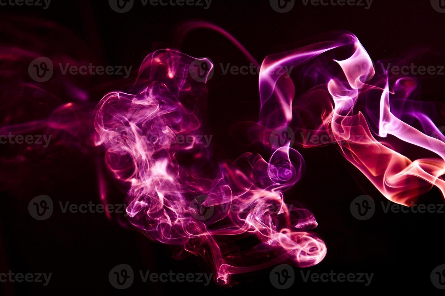 Colorful smoke on black background photo