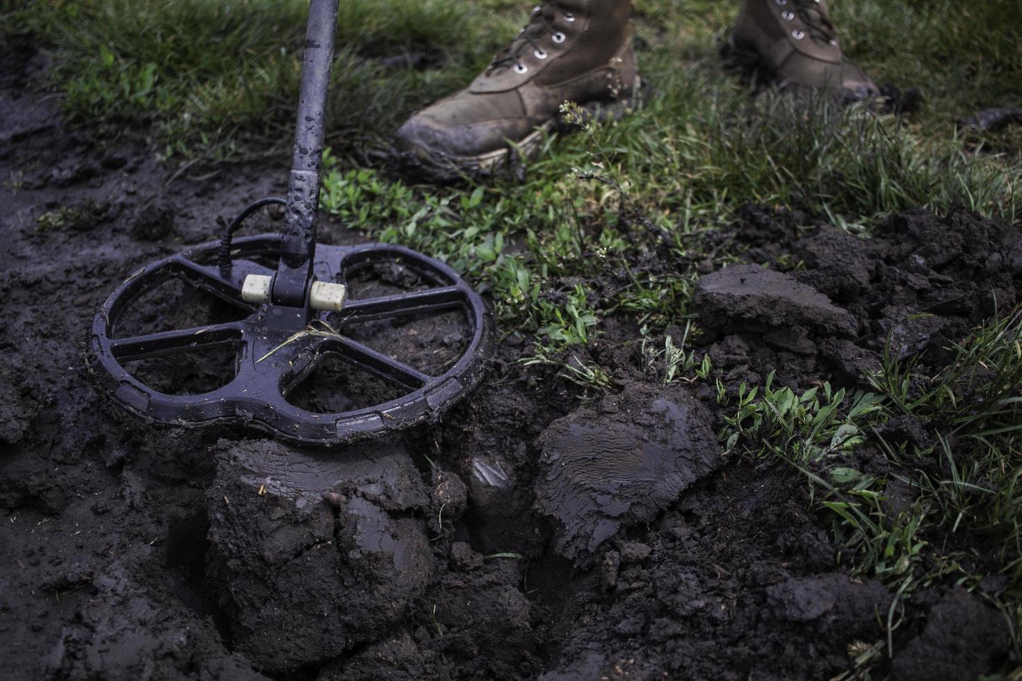 Soldier using a metal detector in fields photo