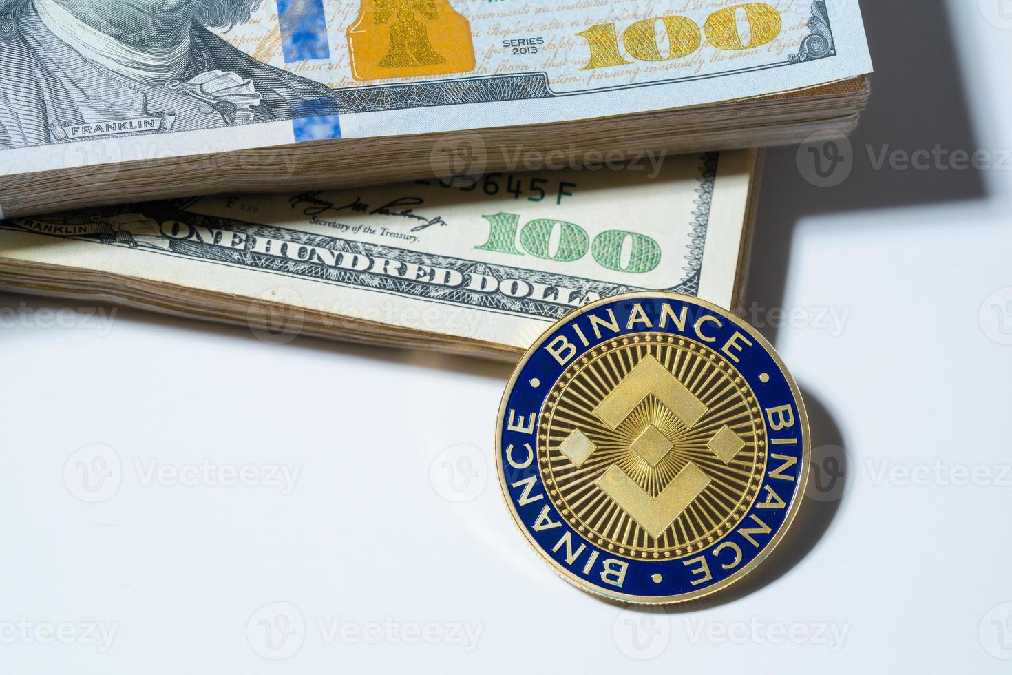 Binance Coin BNB included with Cryptocurrency coin on stack hundred US dollar Money American blockchain technology future money Close up and Macro background photo