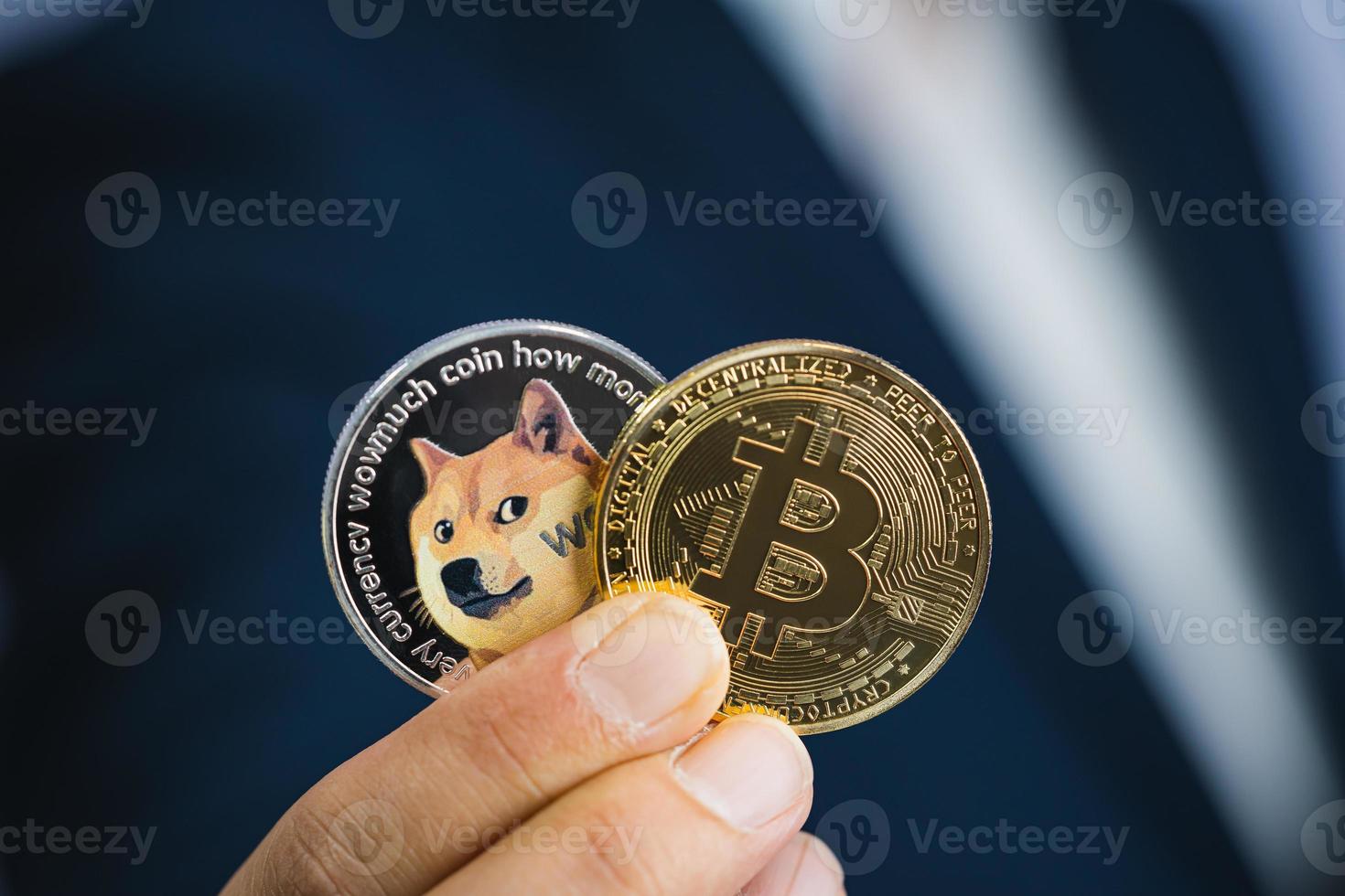 Golden bitcoin coin Dogecoin DOGE group included with Cryptocurrency on hand business man wearing a blue suit. Filed and put and give to me. Close up and Macro photography concept. photo