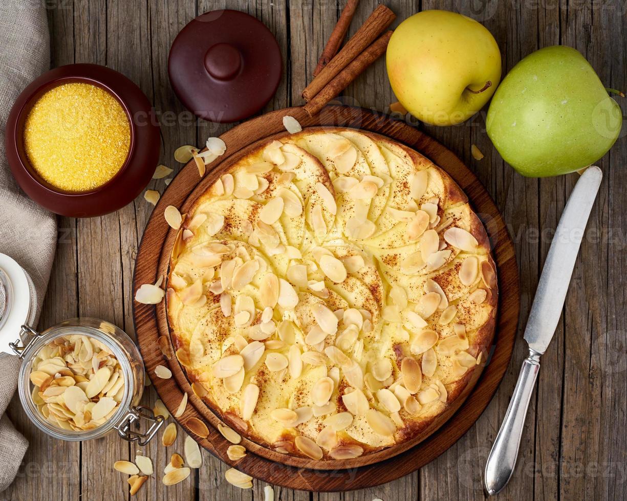 Cheesecake, apple pie, curd dessert with polenta, apples, almond flakes photo