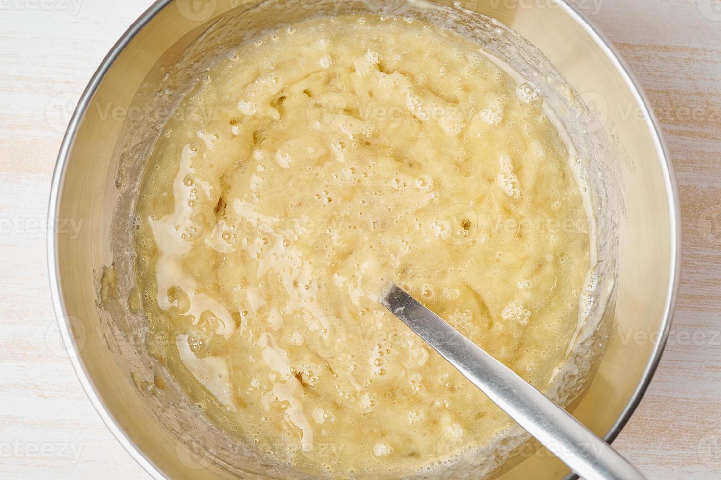 Mashed banana with egg and oil. Step by step recipe. Homemade Banana bread. Top view, white table. photo