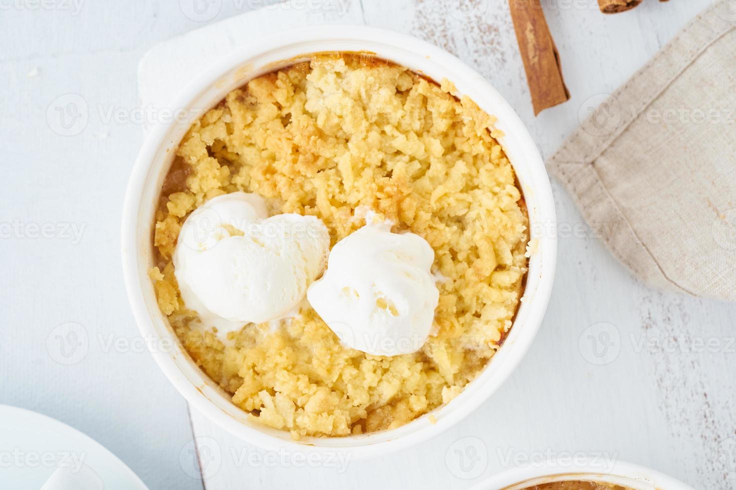 Apple crumble with ice cream, streusel. Morning breakfast on a light gray table. Top view photo