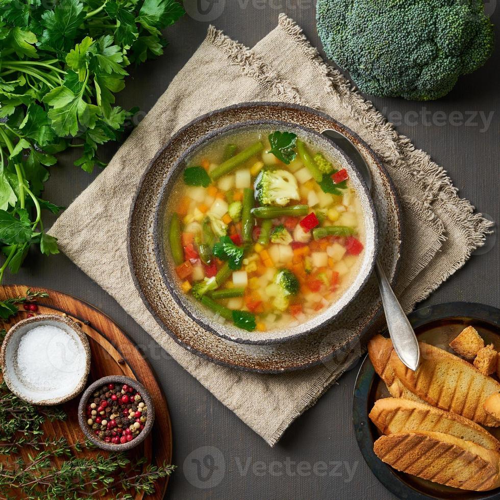 Vegetable soup, dietary vegetarian bright spring dish, linen napkin, top view, photo