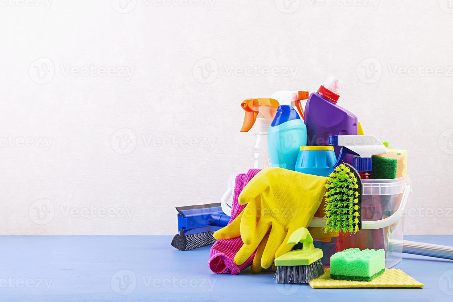 Cleaning service concept. Colorful cleaning set for different surfaces in kitchen, bathroom and other rooms. photo