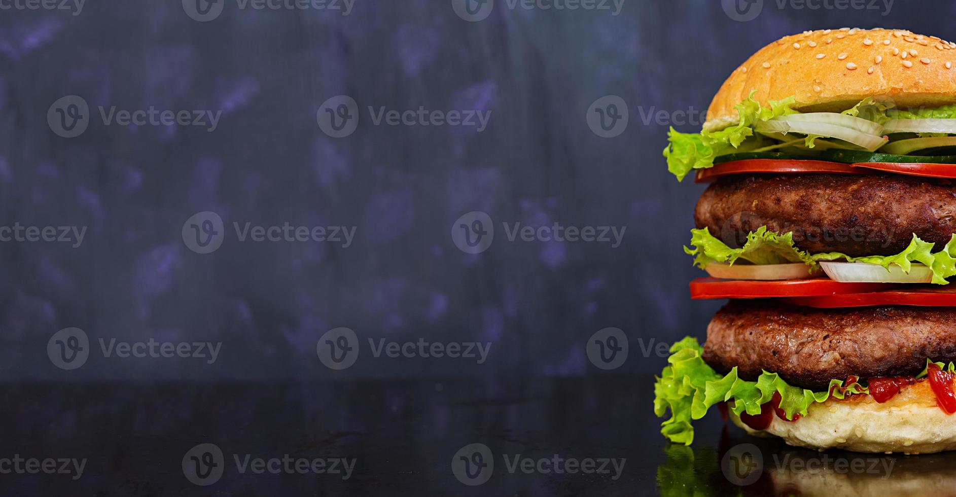 Delicious handmade burger on dark background. Banner. photo