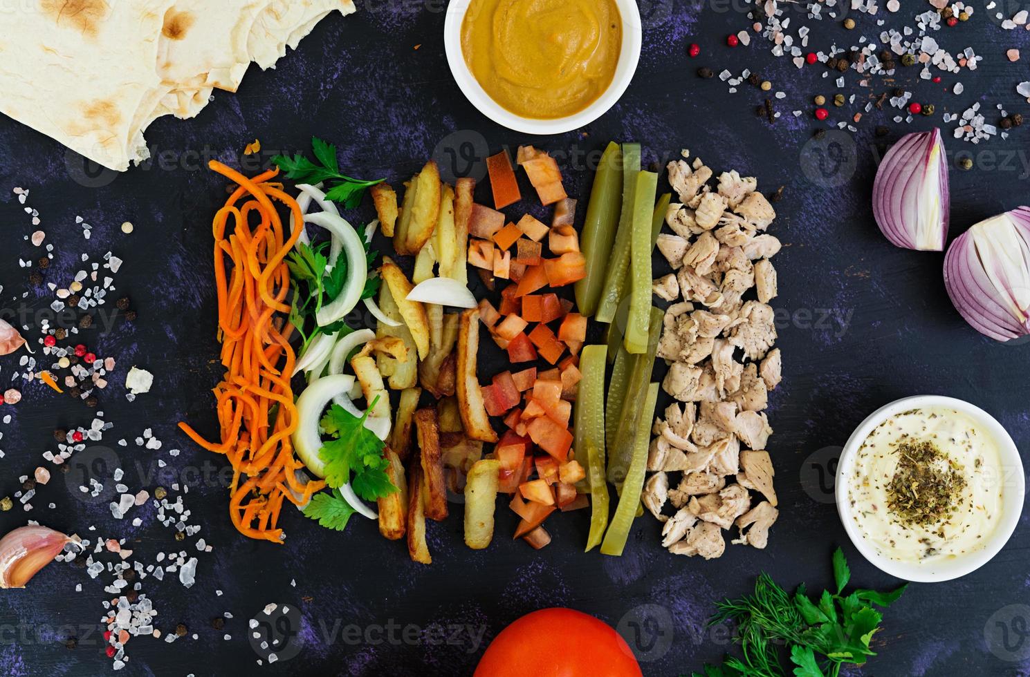 Ingredients for shawarma sandwich on dark background. Top view photo