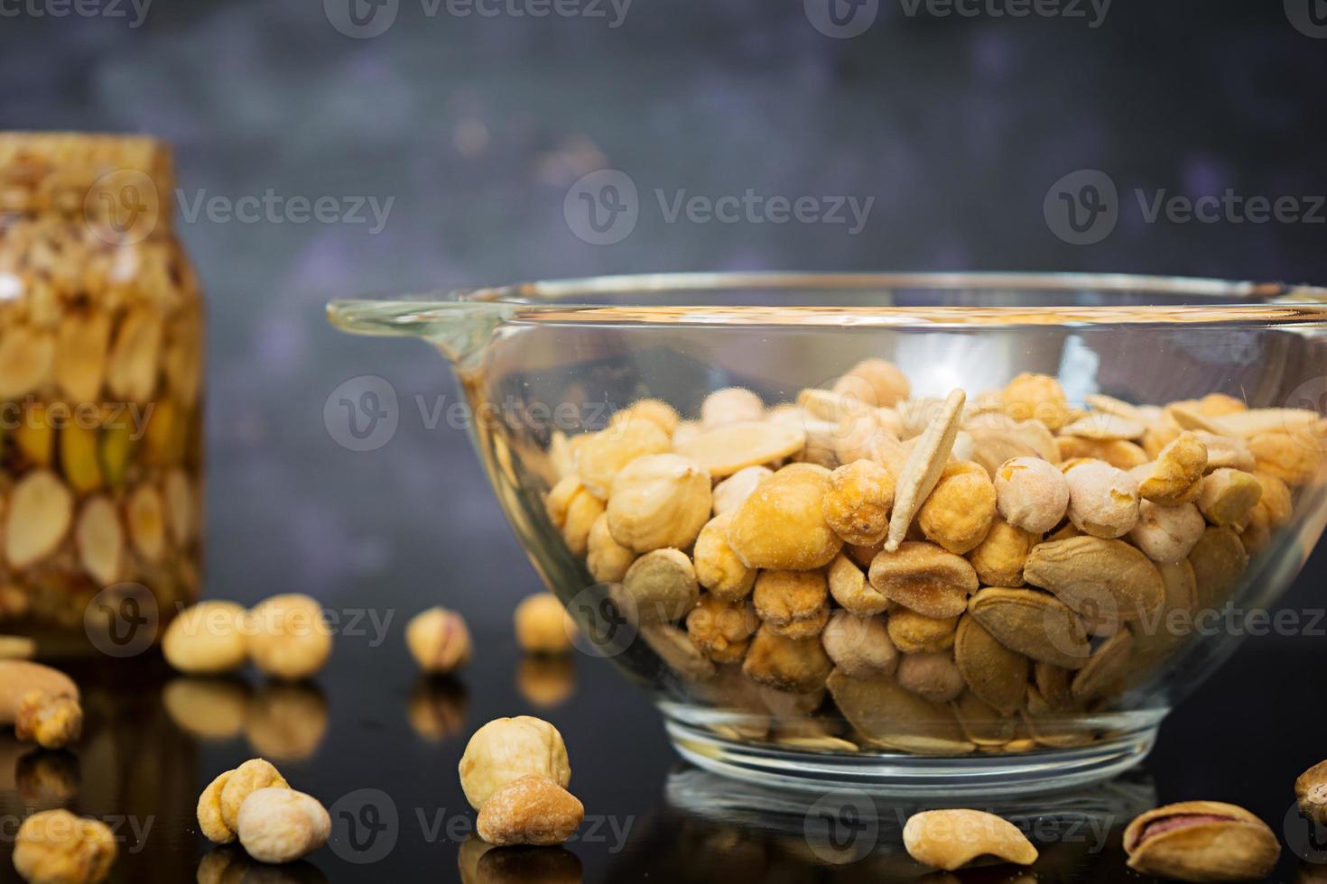 Different kinds of nuts on dark background photo