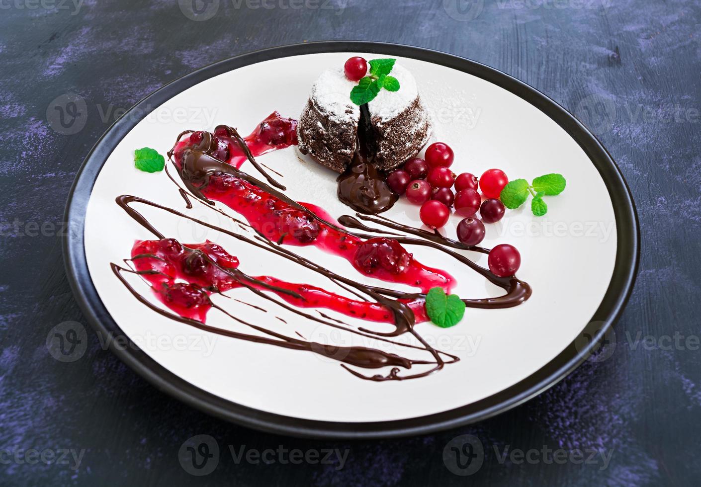 Chocolate fondant with cranberry sauce. photo