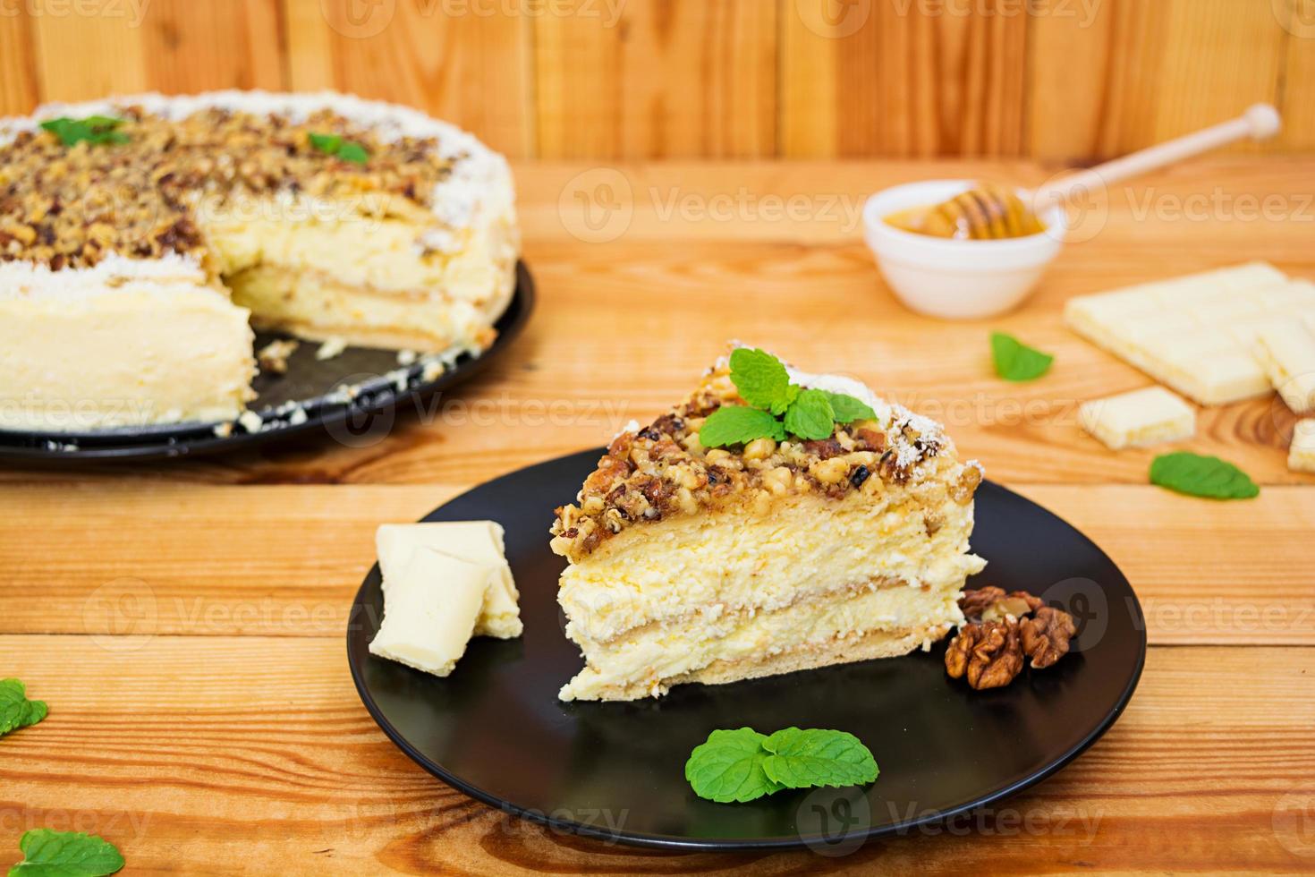 Honey cake with cottage cheese, oranges and nuts, decorated with white chocolate photo