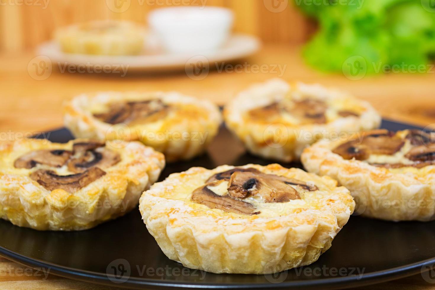 Tartlets with champignons on wooden background photo