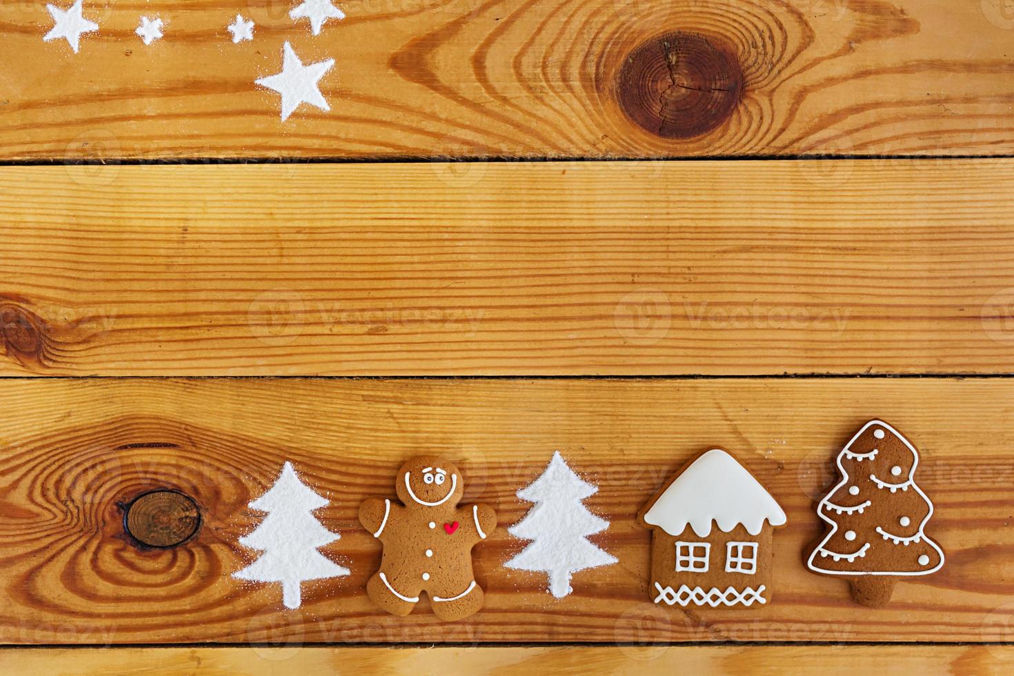 Christmas gingerbread cookies on wooden background photo