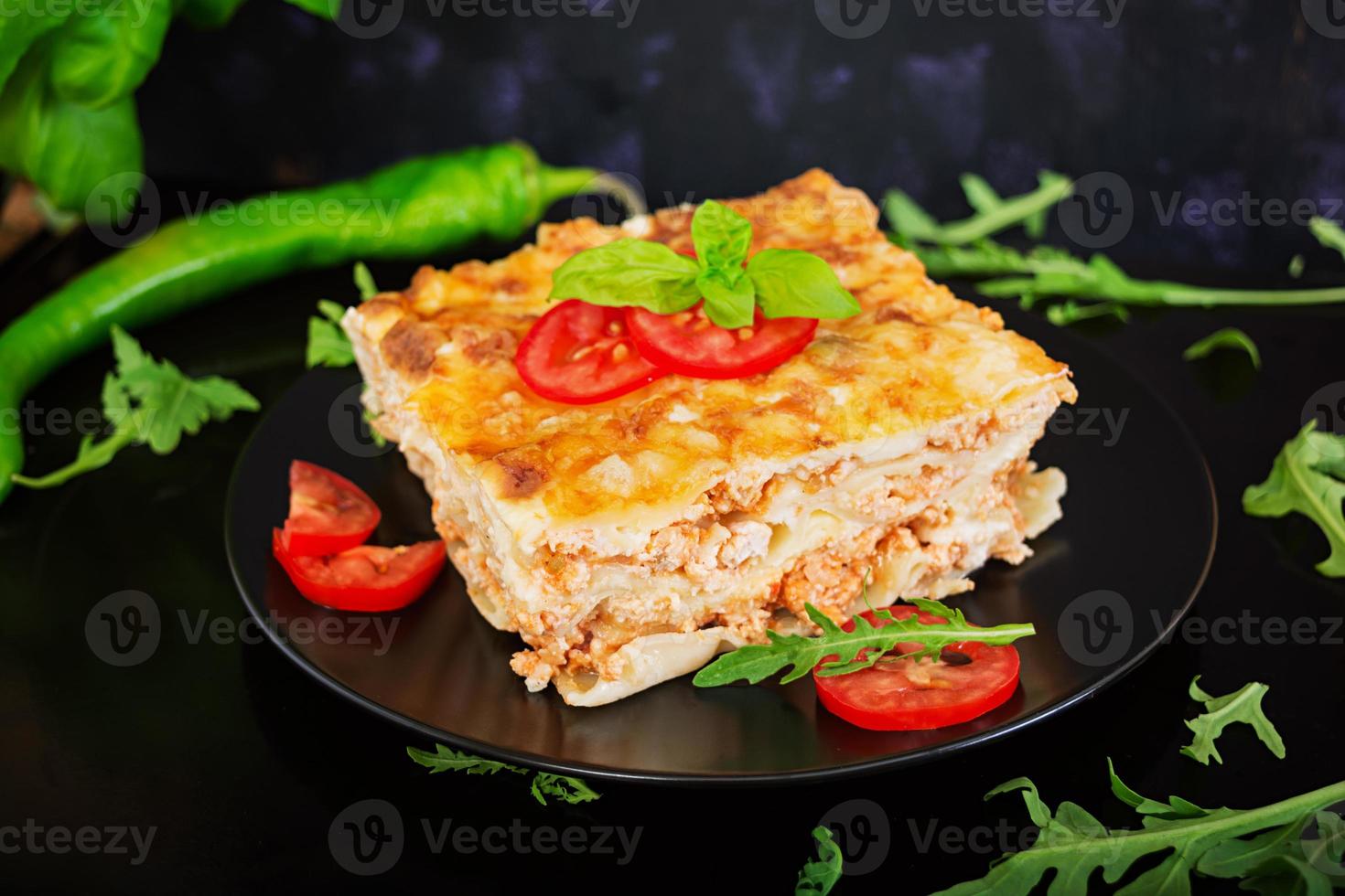Classic Lasagna with bolognese sauce on dark background photo