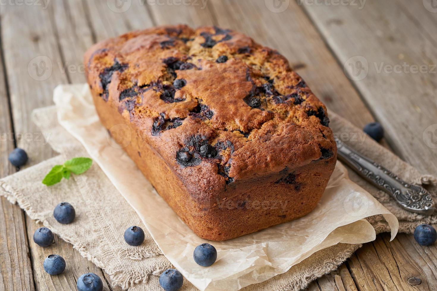 Banana bread on old dark wooden rustic table, slice of cake with banana photo