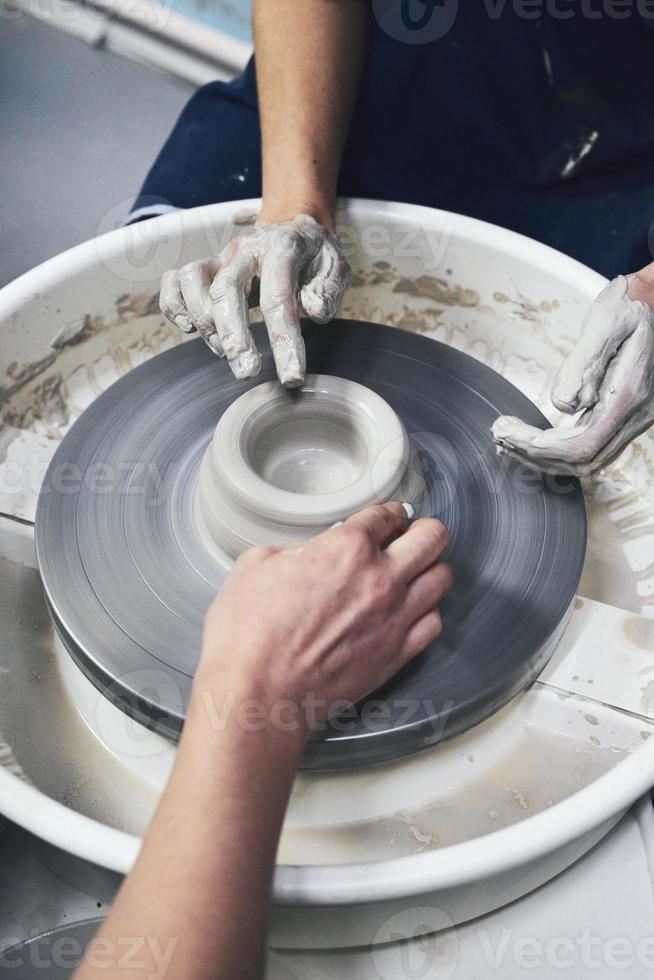 Woman making ceramic pottery on wheel, hands closeup. Concept for woman in freelance photo