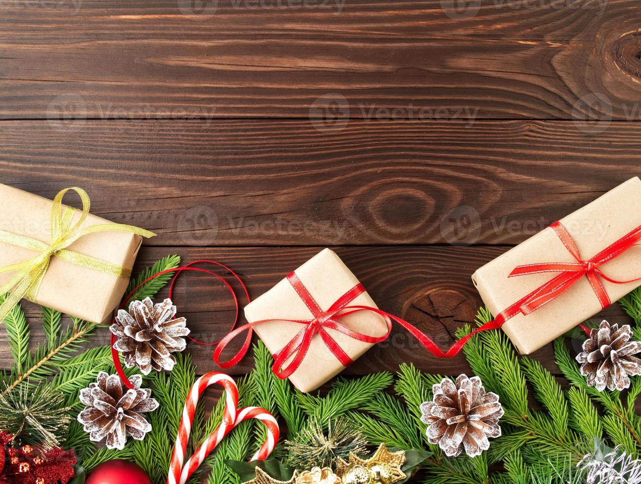 Christmas and Happy New Year dark brown background. Gift Christmas box, fir branches photo