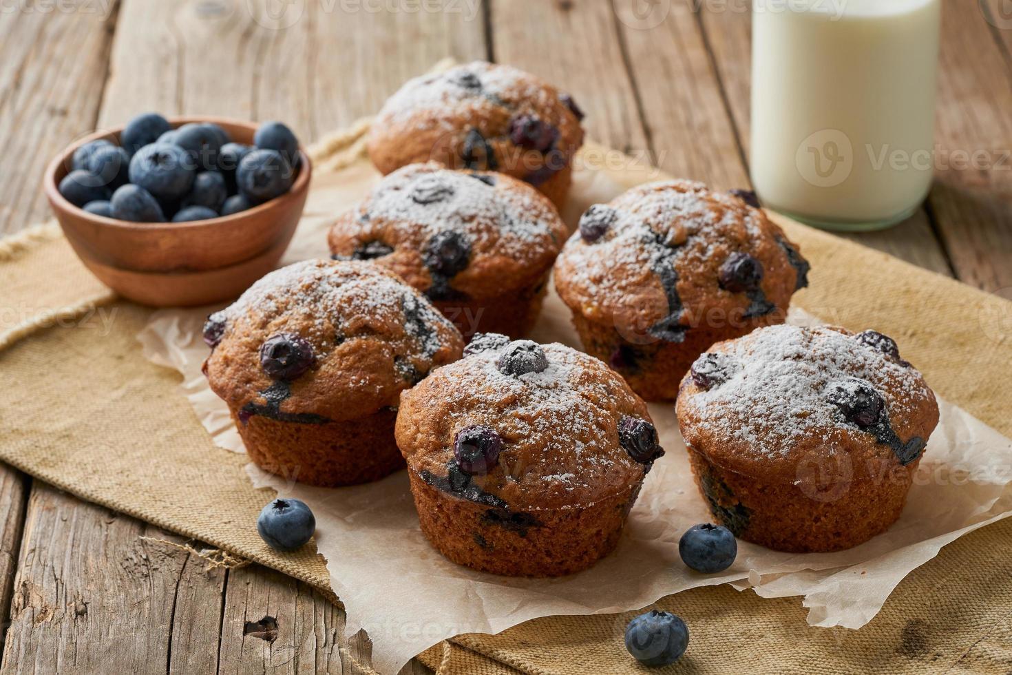 Blueberry muffin, side view. Cupcakes with berries on old linen napkin photo