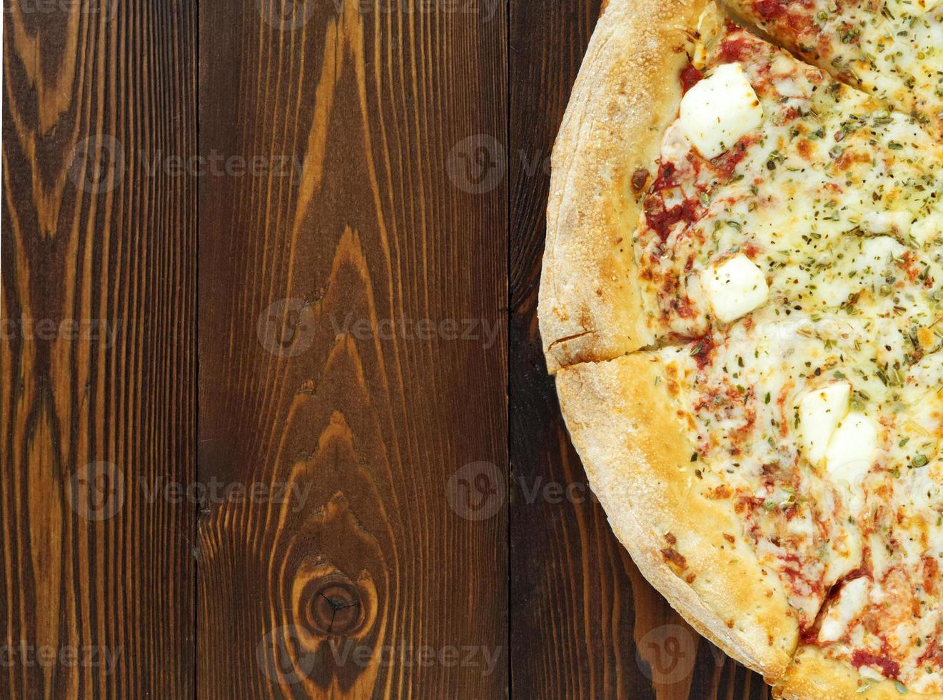 Part of Four cheese pizza with Dor-blue, Parmesan, feta, oregano, mozzarella, tomato sauce photo