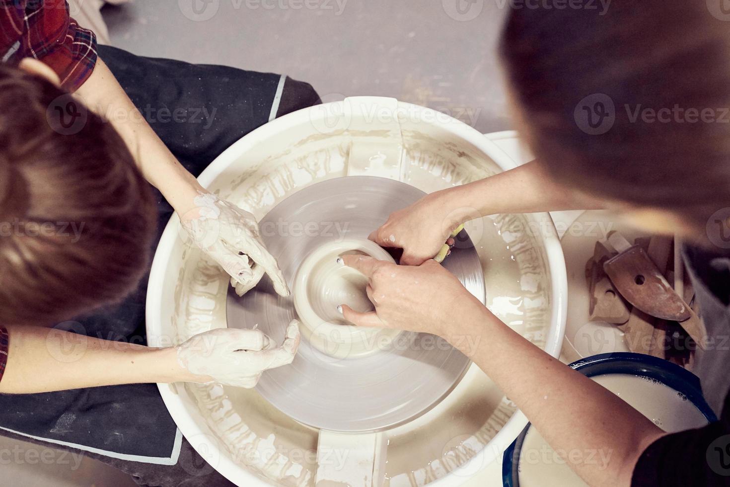 Woman making ceramic pottery on wheel, hands closeup. Concept for woman in freelance photo