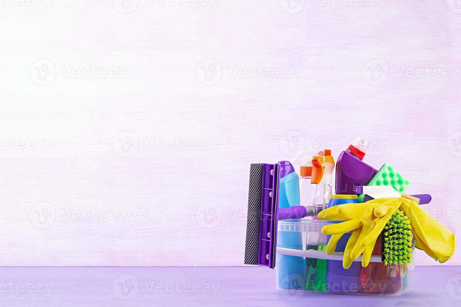 Cleaning service concept. Colorful cleaning set for different surfaces in kitchen, bathroom and other rooms. photo