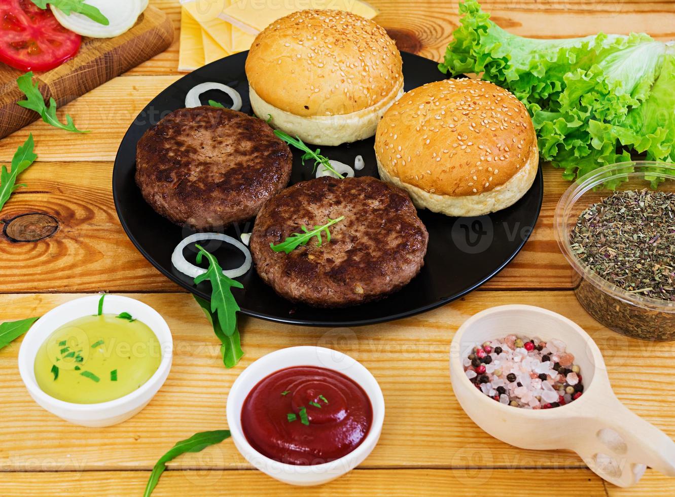 Ingredients for burger on wooden background. Top view photo