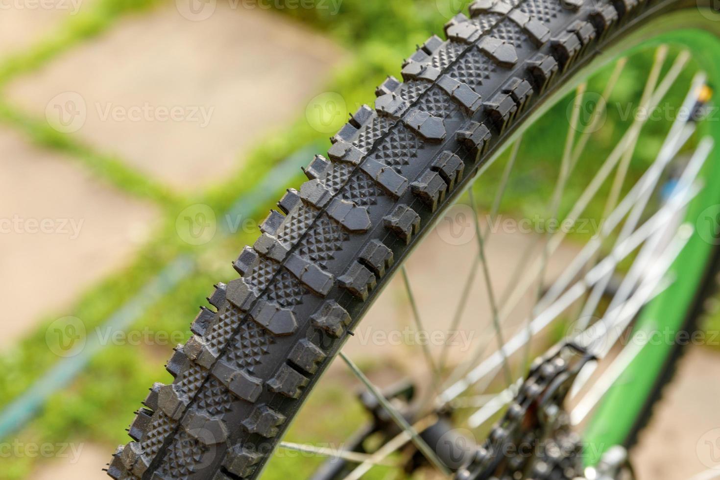 Bike waiting mechanic for repair in bicycle repair shop, outdoor. Bicycle wheel close up ready for examines, fixes modern cycle transmission system. Bike maintenance, sport shop concept. photo