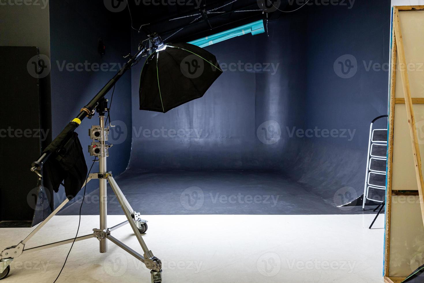 Empty photo studio with lighting equipment. Photographer workplace interior with professional tool set gear. Flash light black background scenes ready for studio shooting. Modern photographer studio