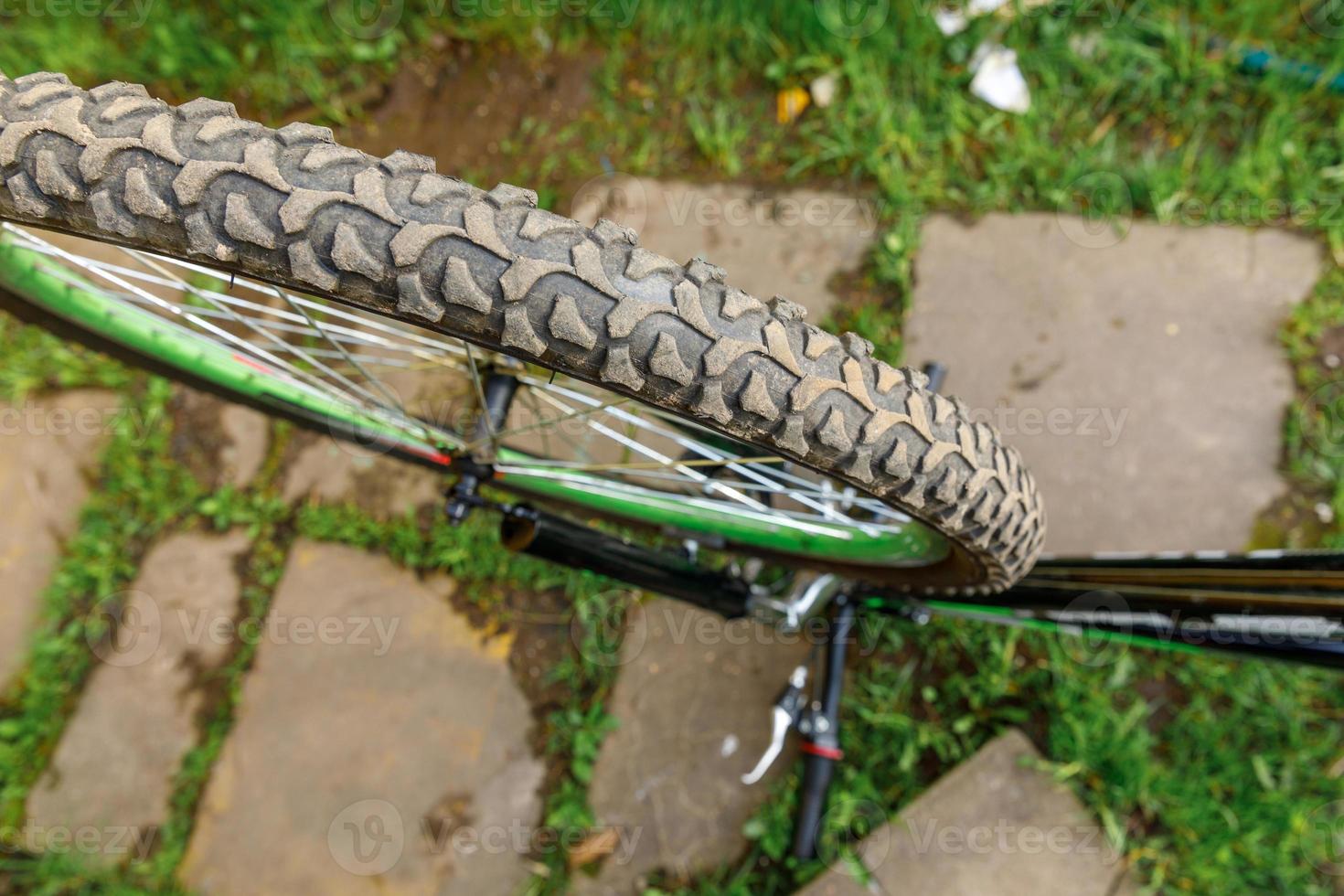 Bike waiting mechanic for repair in bicycle repair shop, outdoor. Bicycle wheel close up ready for examines, fixes modern cycle transmission system. Bike maintenance, sport shop concept. photo