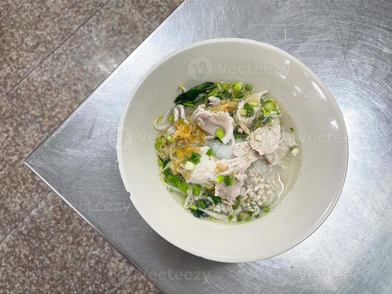 Thailand traditional noodles served with sliced pork and minced pork. A popular delicious street food of Thai peoples. Asian food. Shot from above. photo