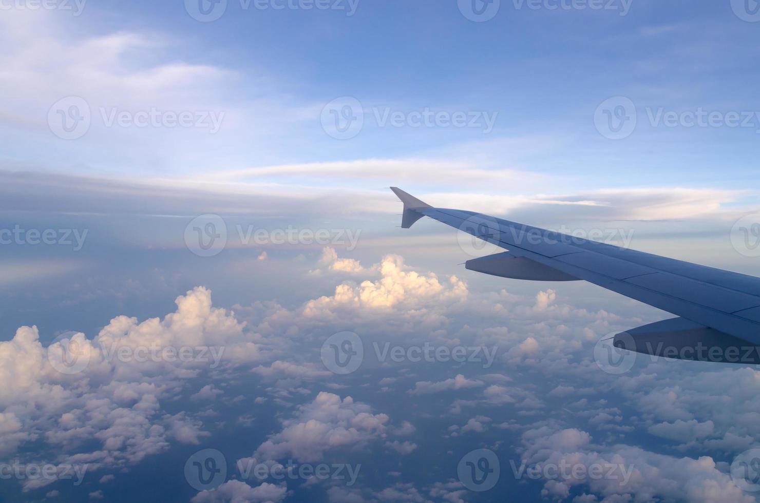 Aerial view over white puffy clouds horizon background. Beautiful sky and cloud texture view from airplane. photo