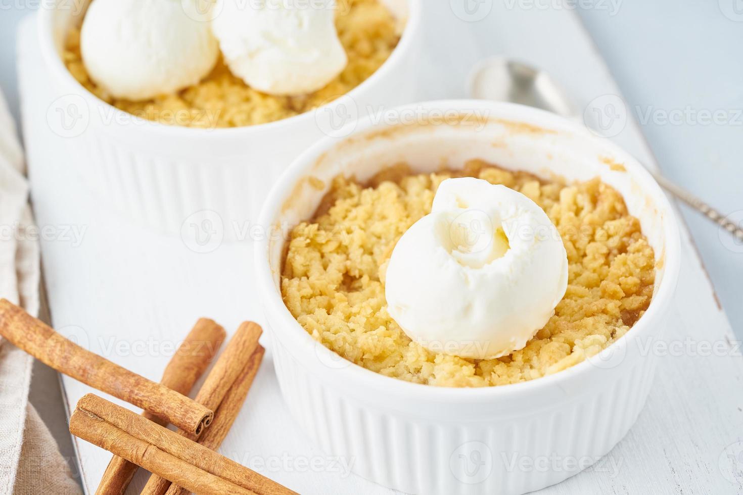 Apple crumble with streusel on a light gray table, close up. Morning breakfast. photo