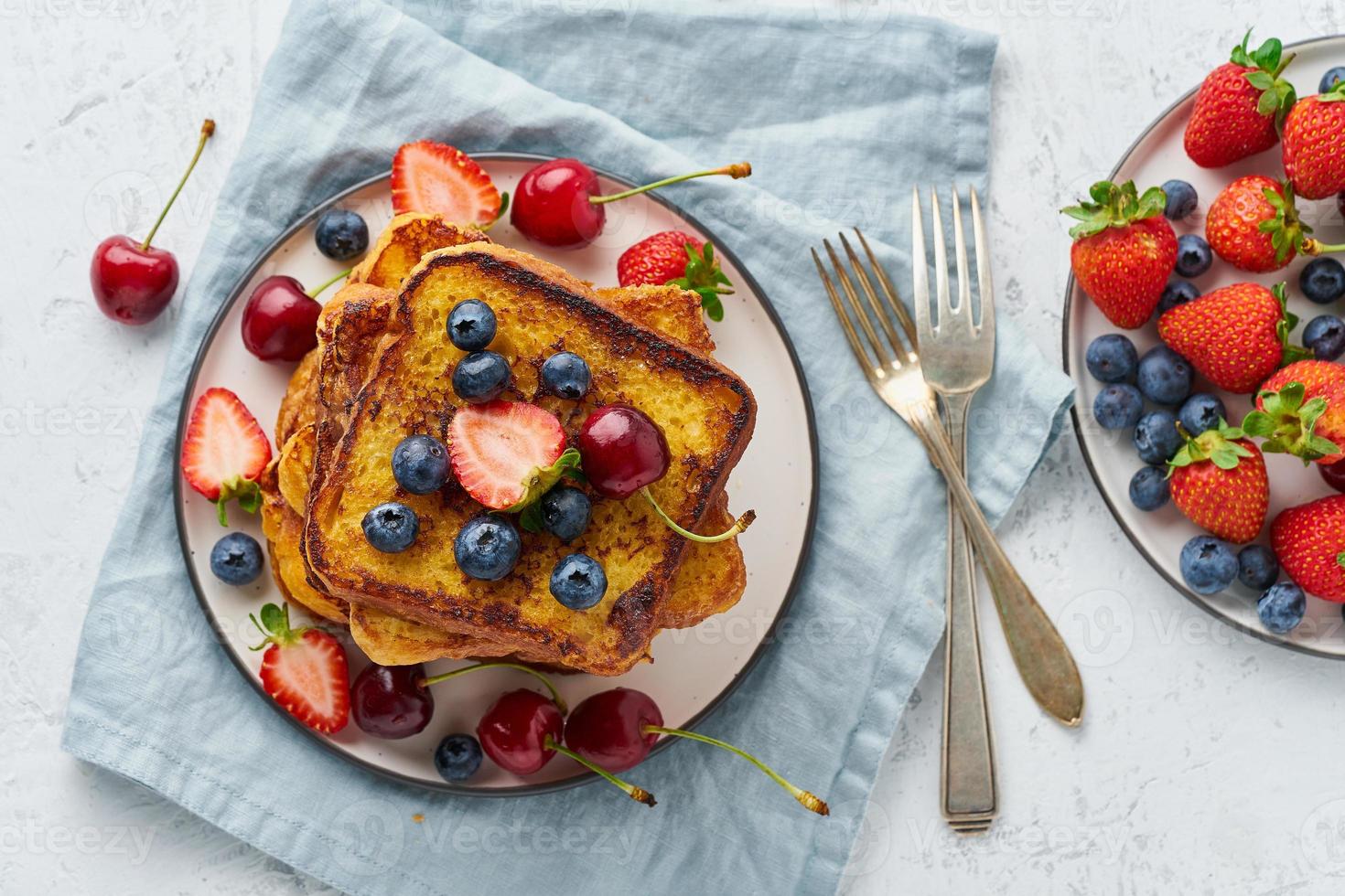 French toasts with berries, brioche breakfast, white background top view photo