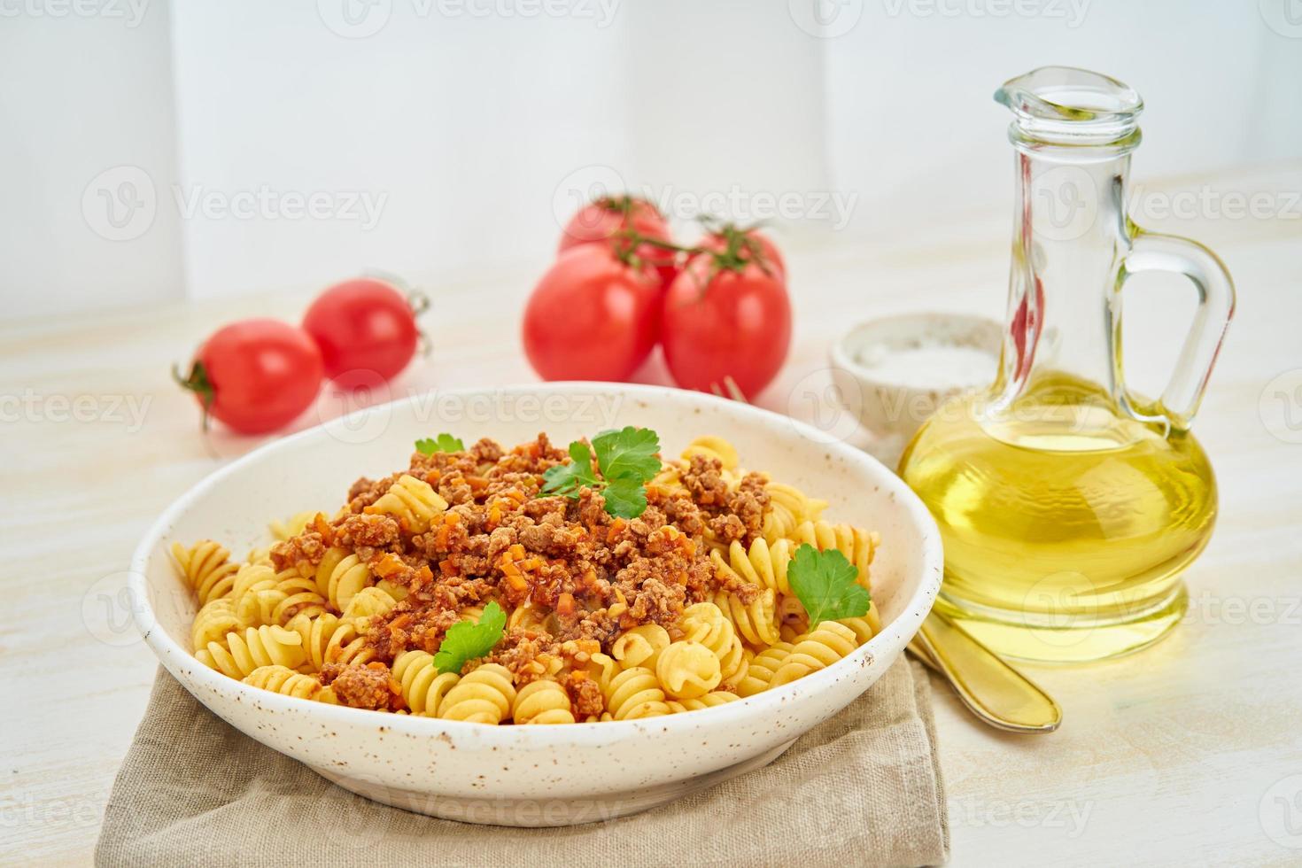 Bolognese pasta. Fusilli with tomato sauce, ground minced beef. photo