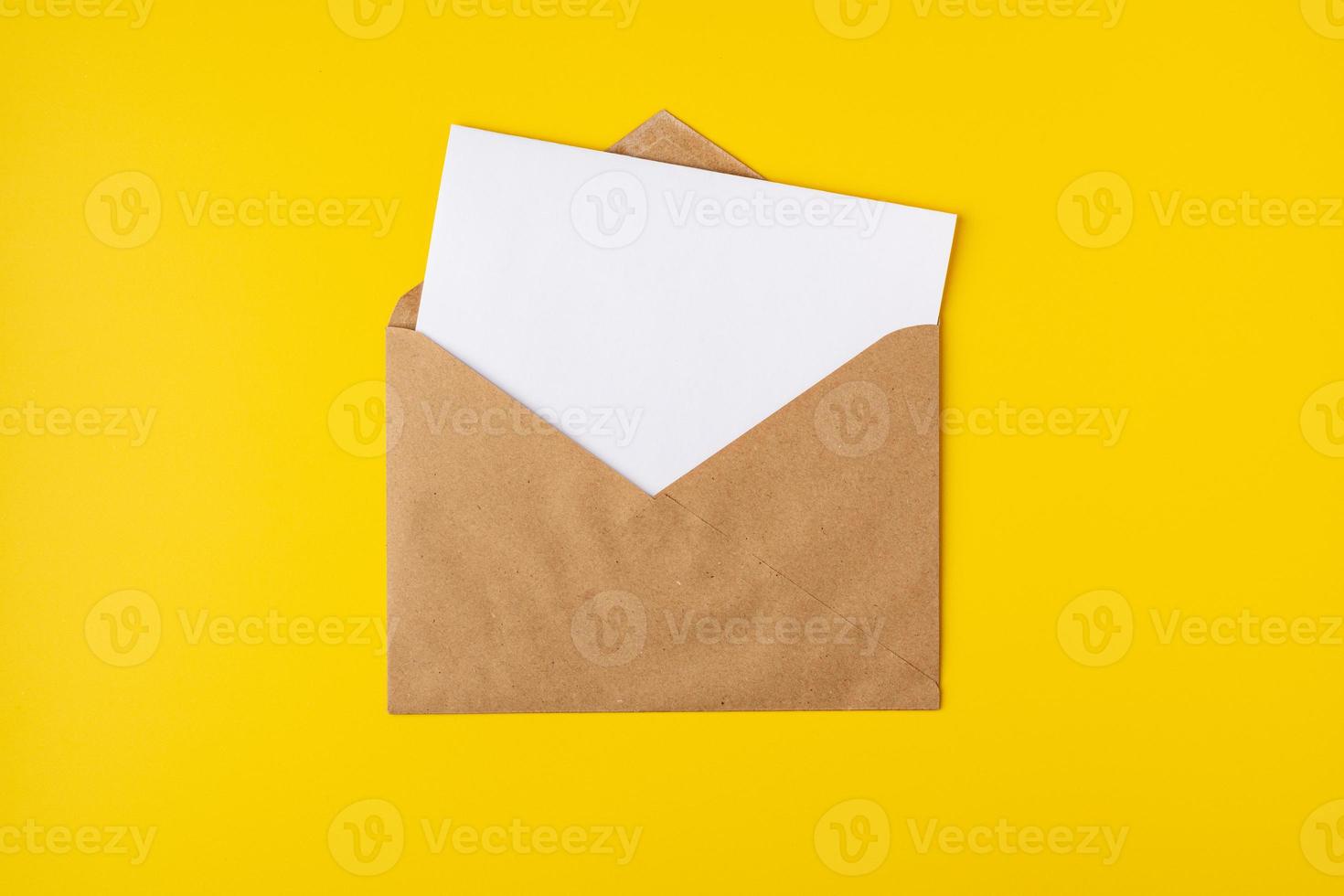 Realistic mockup blank white letter craft paper envelope on yellow backdrop front view, template photo