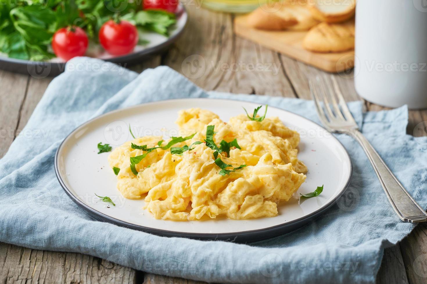 Scrambled eggs, omelette, side view. Breakfast with pan-fried eggs photo