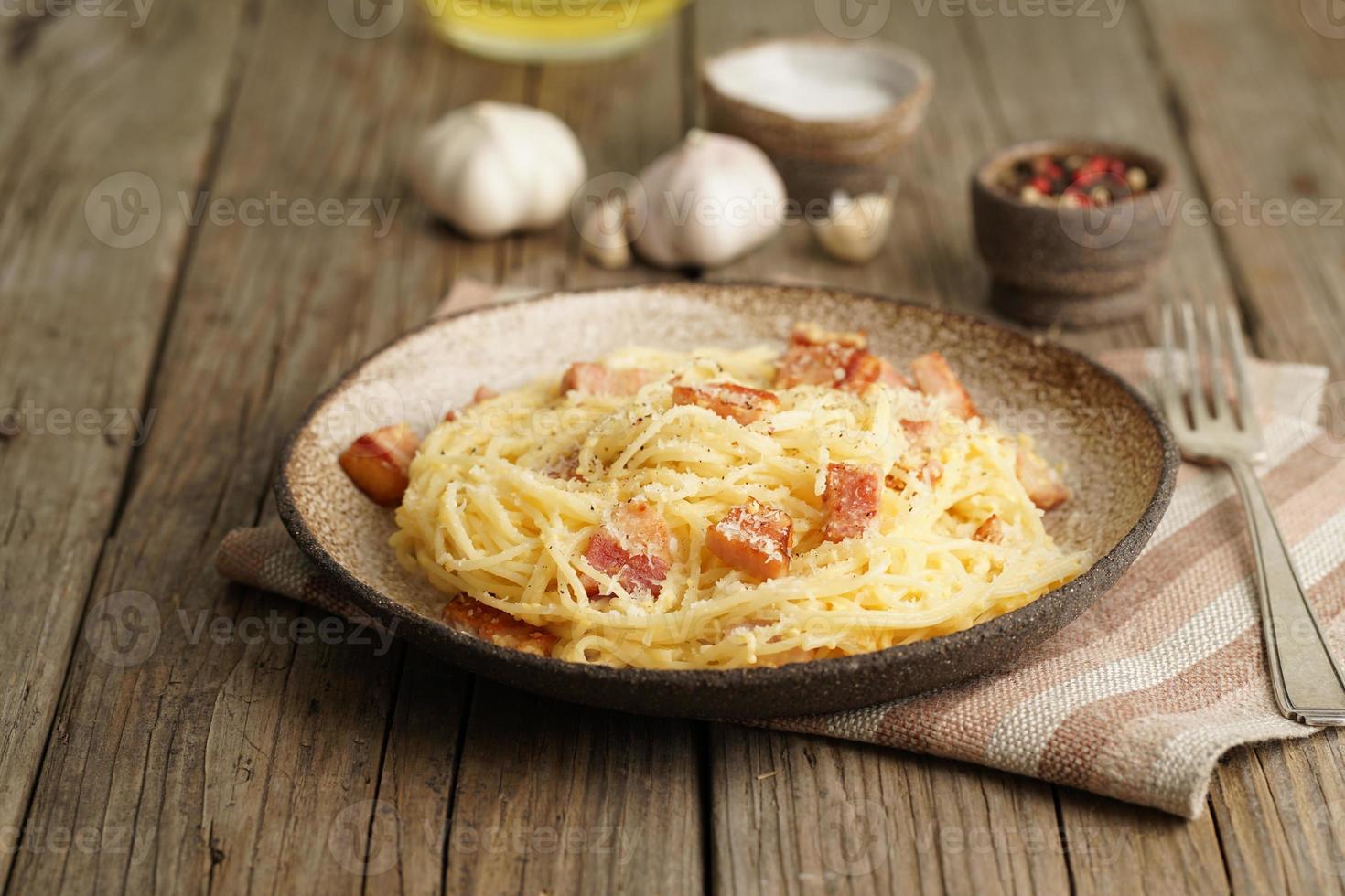 Carbonara pasta. Spaghetti with bacon, egg, parmesan cheese. Traditional italian cuisine. photo
