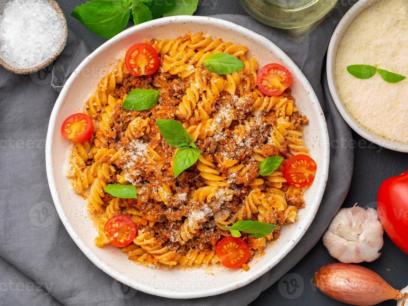 Bolognese pasta. Fusilli with tomato sauce, ground minced beef photo