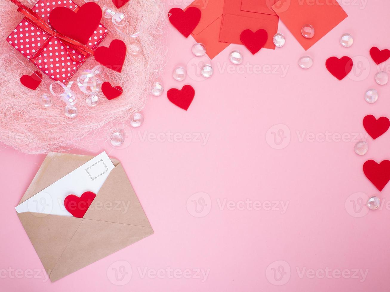 gift in red gift box with bow, smart phone, envelope, card, red heart, pink background, flat lay, copy space, mockup photo