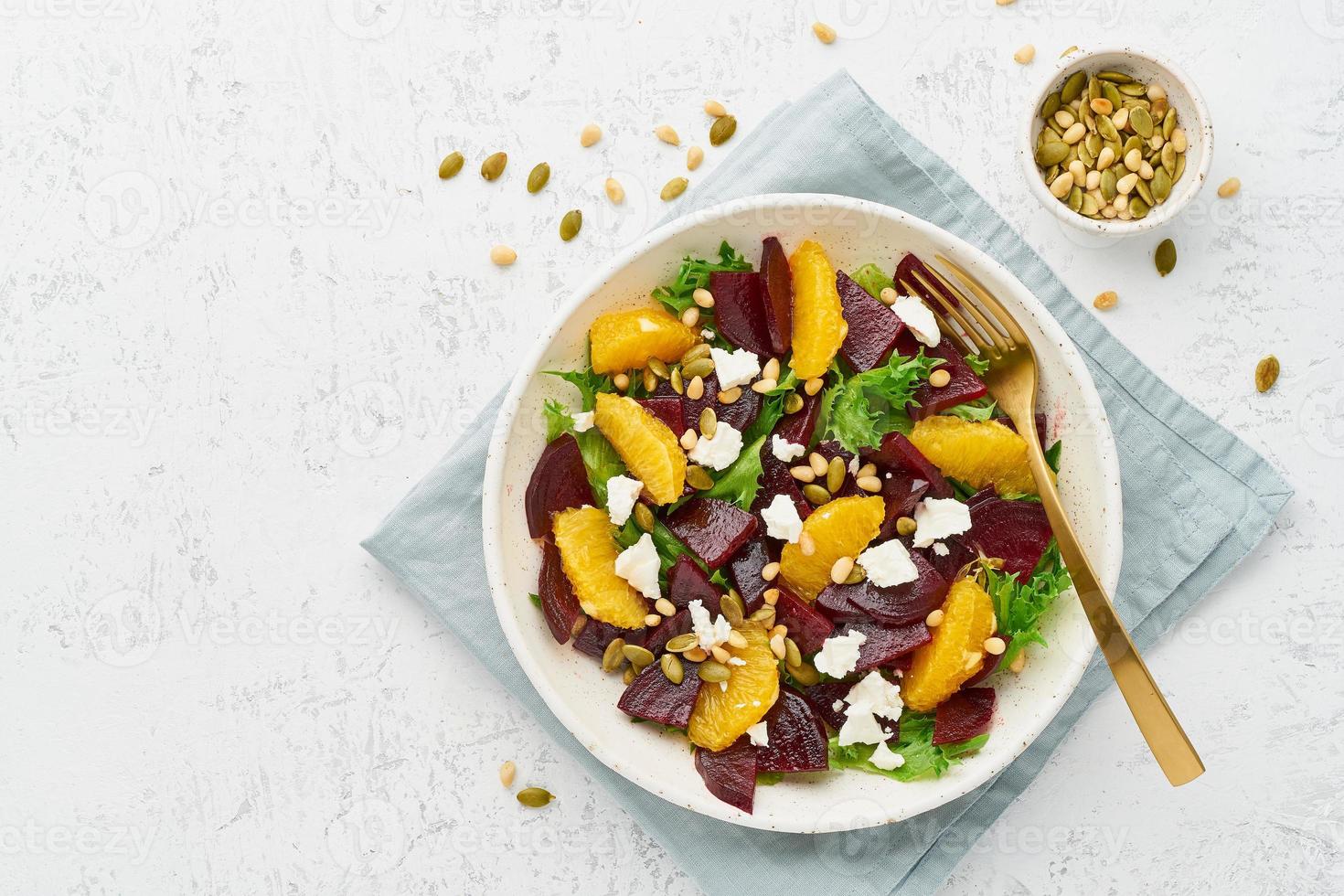 Vegan salad with beet curd avocado orange feta ricotta and pumpkin seeds photo