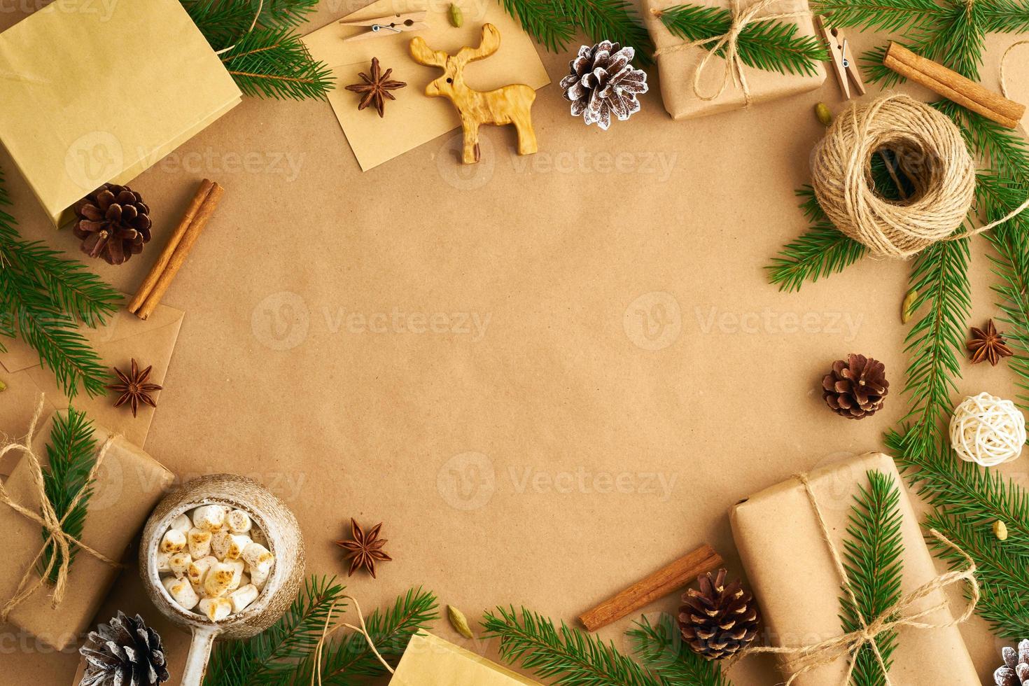 Christmas and Happy New Year zero waste craft paper background. Handmade gift Christmas box, fir branches, cup with hot chocolad, marshmallows, top view, copy space. Ecofriendly plastic free concept photo