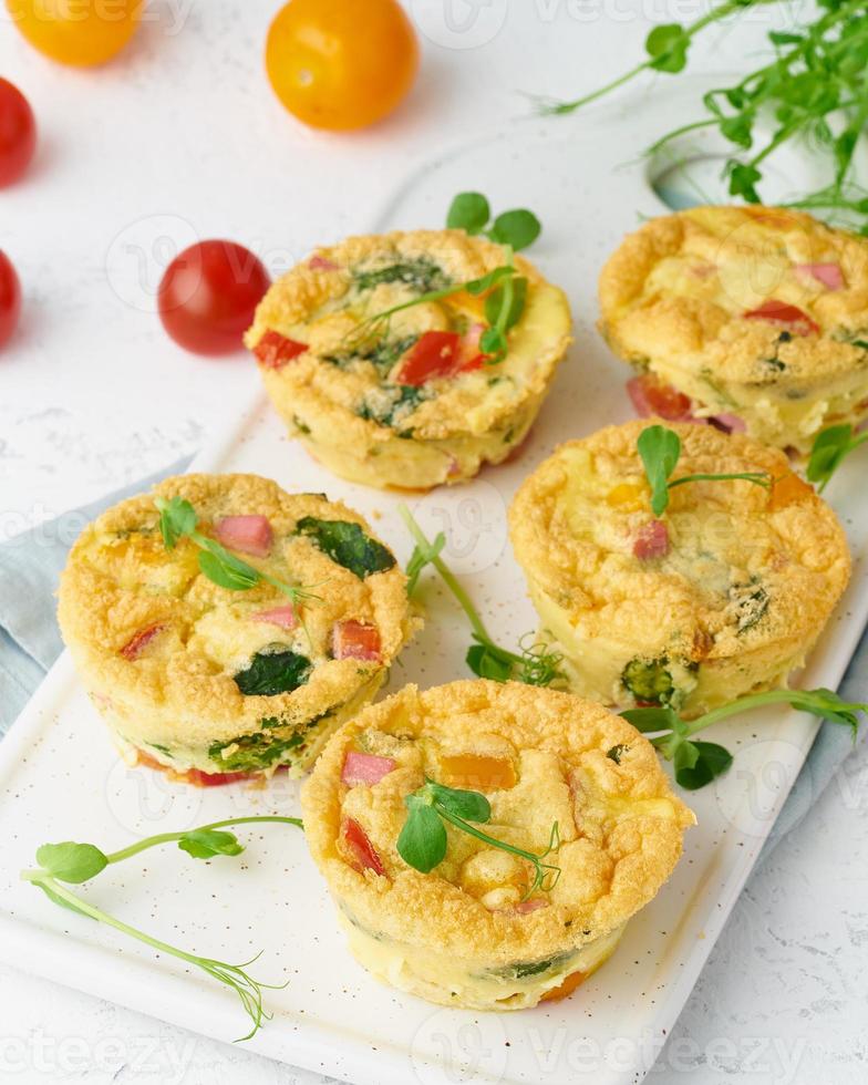 omelet with tomatoes and bacon, baked eggs with spinach and broccoli photo