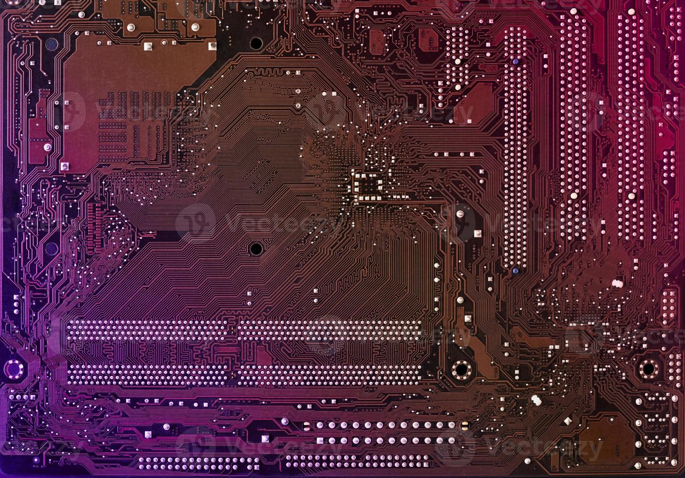 Computer motherboard background with blur neon multicolor glow, pc backdrop, close up photo